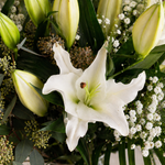 Side view of Lovely Lilies white lily bouquet with eucalyptus and phoenix palm leaves available for same-day Dublin delivery