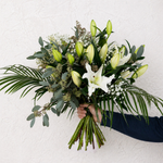 Close up of Lovely Lilies bouquet showing white lily blooms and soft gypsophilia in an elegant fragrant arrangement