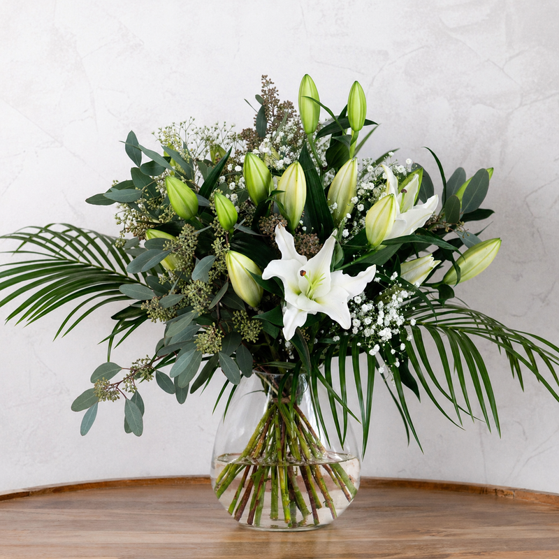 Full arrangement of Lovely Lilies bouquet showing white lilies, gypsophilia and eucalyptus hand-tied by experienced florists for delivery across Ireland