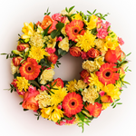 Circular orange and yellow funeral wreath handcrafted by Dublin florist The Flower Factory