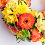 Up-close Orange wreath of roses and gerberas for graveside tribute Ireland