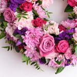 Up-close of a pink wreath of roses and carnations for graveside tribute Ireland
