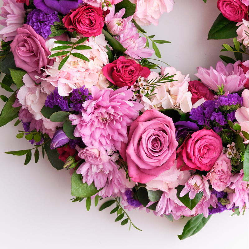 Up-close of a pink wreath of roses and carnations for graveside tribute Ireland