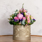 Top view of Peony Hatbox arrangement showing peony roses, statice and hypericum in a deluxe hatbox available for same-day Dublin delivery