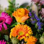 Side view of Surprise colourful flower bouquet with solidago and seasonal greens available for same-day Dublin delivery