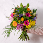 Close up of Surprise bouquet showing mini gerbera, spray chrysanthemums and hypericum in a vibrant colourful arrangement