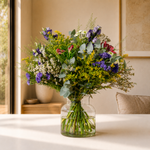 Wild and Wonderful wild flower bouquet with waxflowers, camomile and purple statice wrapped in recycled burlap, hand-tied fresh to order for delivery across Ireland