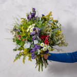 Full arrangement of Wild and Wonderful wild flower bouquet with camomile, waxflowers and purple statice hand-tied by experienced florists for delivery across Ireland