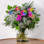 Half Dozen Rainbow Roses bouquet showing vivid multicoloured roses with gypsophilia and seasonal greenery hand-tied fresh to order for delivery across Ireland