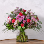 Full arrangement of Pretty in Pink bouquet showing vibrant pink flowers with salal and eucalyptus foliage available for same-day Dublin delivery