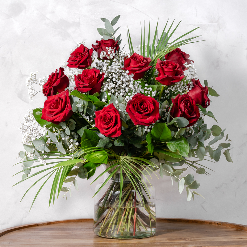 Full arrangement of Dozen Red Roses with phoenix palm leaves and salal foliage available for same-day Dublin delivery
